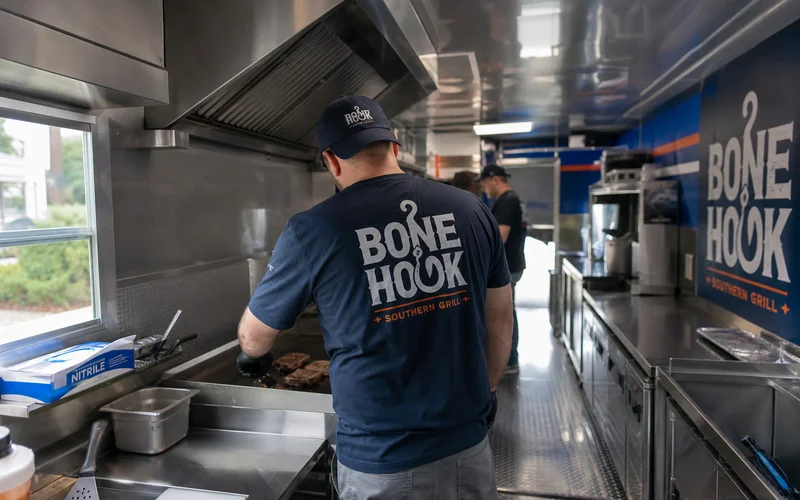 Interior of a finished food trailer build with stainless commercial kitchen