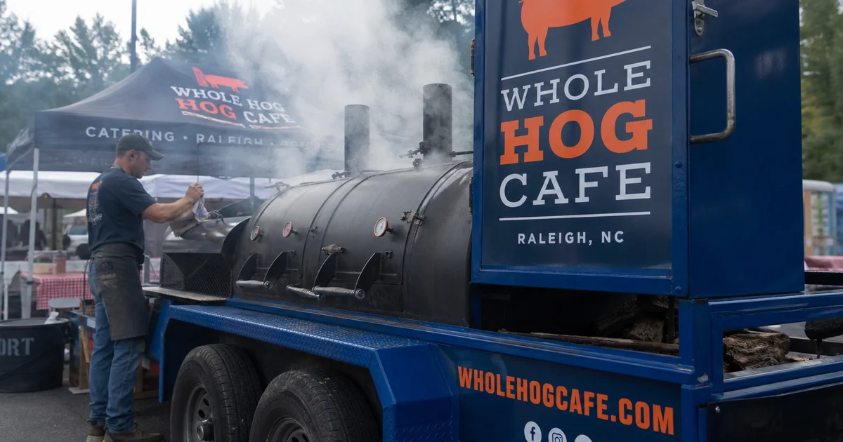 A custom BBQ smoker trailer with offset firebox at a NC festival