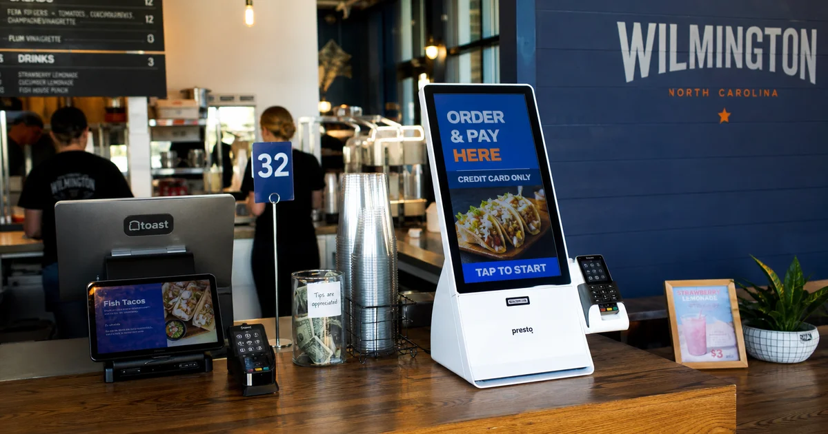A modern restaurant POS terminal and self-order kiosk in use