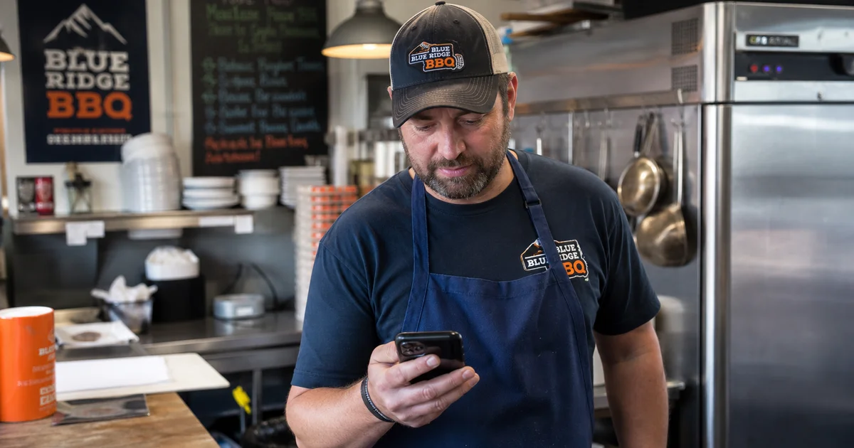 A North Carolina restaurant owner using a phone to start a 60-second pre-qualification