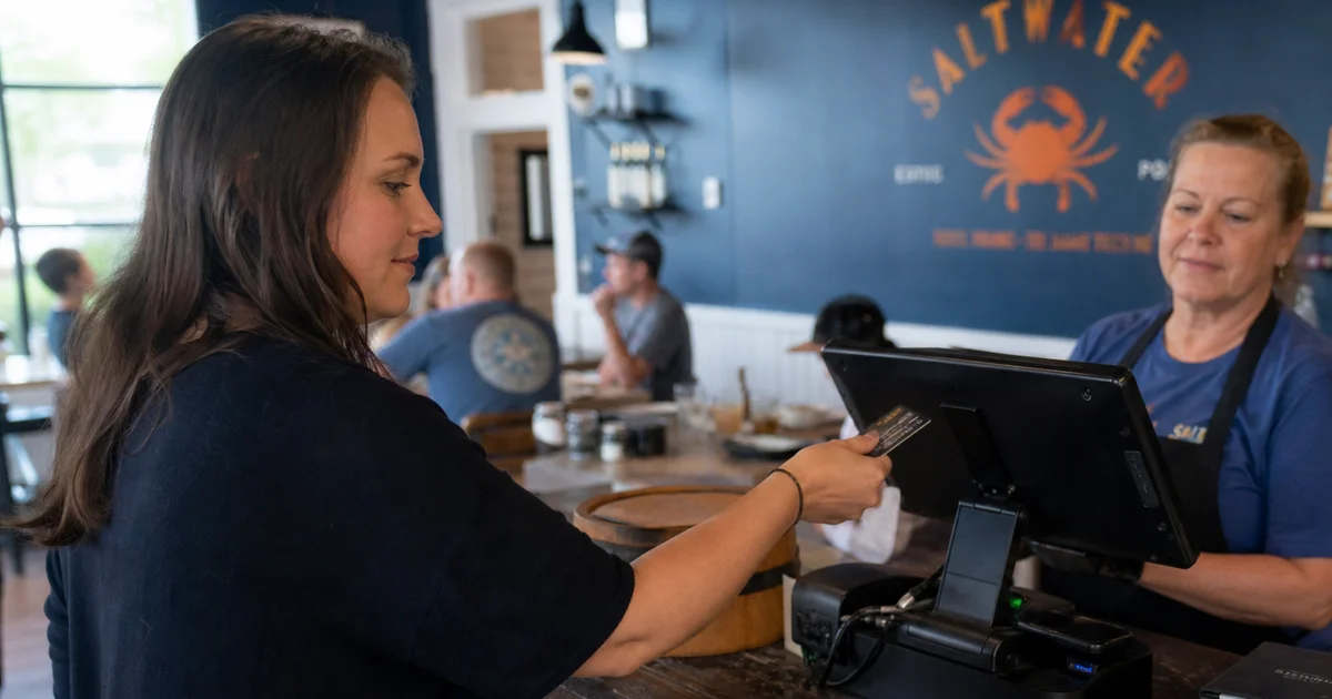 A restaurant POS terminal processing credit card payments