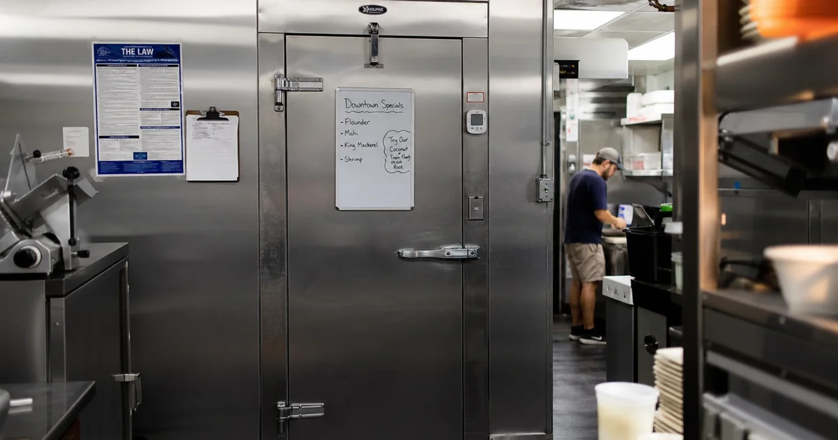 A stainless steel walk-in cooler in a commercial NC restaurant kitchen
