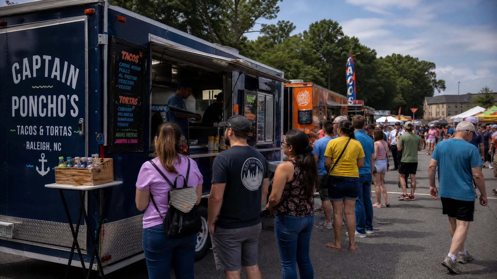 A busy food truck festival in North Carolina with customers lined up at a colorful food truck